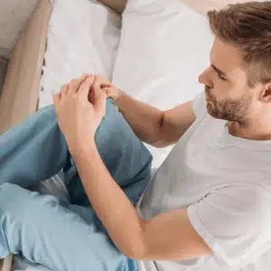 Man performs gentle movements at home as part of his knee replacement recovery routine