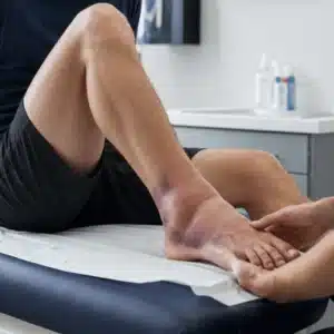 A provider checks a swollen and bruised ankle during an orthopedic urgent care assessment
