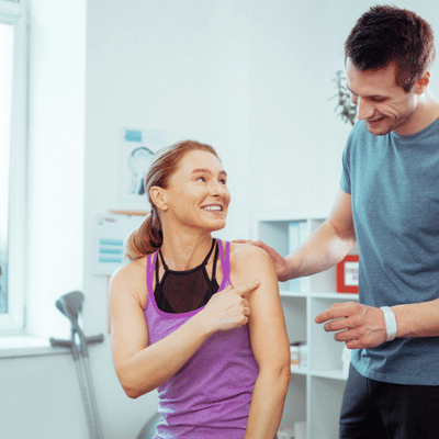 Coach discusses shoulder discomfort with athlete, demonstrating shoulder specialist dallas tx treatment planning and support